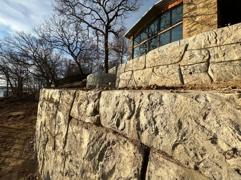 A sturdy hardscape wall made of natural stone, adding texture and elegance to the outdoor space.