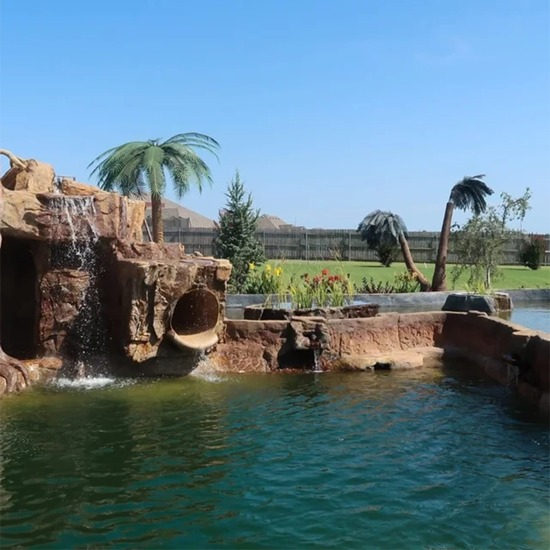 A natural swimming pool in a backyard surrounded by palm trees A natural swimming pool in a backyard surrounded by palm trees