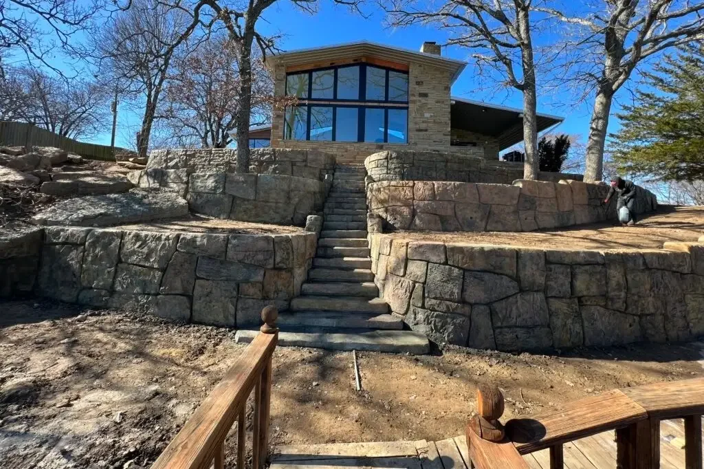 A walkway leading up to a house with retaining walls surrounding the path